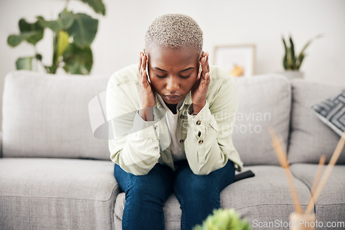 Image of Anxiety, headache and pain with a black woman on a sofa in the living room of her home for mental health. Stress, burnout or vertigo and a young person in an apartment with depression or a migraine