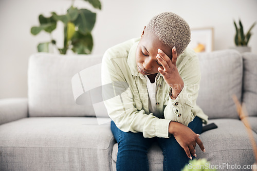 Image of Woman, depression and headache in home for anxiety, mental health and stress of mistake, debt or crisis. Tired, sad and frustrated african person with emotional trauma, broken heart and worry on sofa