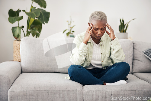 Image of Stress, headache and burnout with a black woman on a sofa in the living room of her home for mental health. Anxiety, pain or vertigo and a young person in an apartment with depression or a migraine