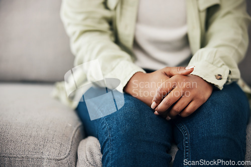 Image of Stress, hands and woman on a sofa with depression after news of cancer or diagnosis in her home. Anxiety, zoom and female with mental health crisis for infertility results, disaster or mistake fail