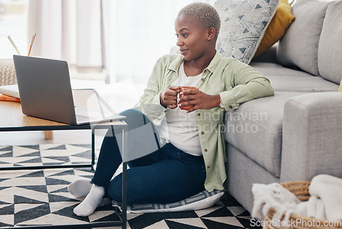 Image of Woman, coffee and watch movies on laptop, streaming multimedia or news show on floor of home. Happy african person relax with cup of tea, computer or social media subscription of online entertainment