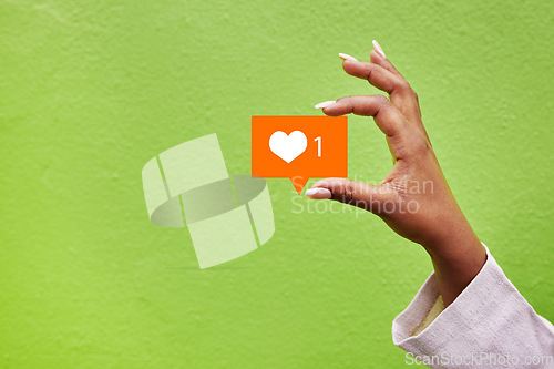 Image of Hand, heart and like emoji with a person on green background mockup in studio for social media. Banner space, icon and post with an adult holding a logo closeup for communication or networking