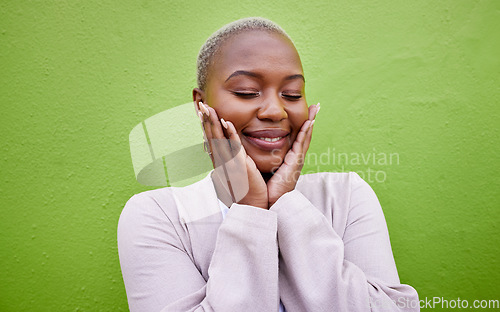 Image of Happy, black woman and self love or stylish on a green wall for fashion, thinking or trendy. Smile, young and a calm African girl or fun model with confidence, fashion or peace on a background