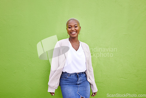 Image of Portrait, fashion and happy black woman on green wall background mockup space. Positive designer, smile and confident African person in style, casual clothes and trendy aesthetic in Nigeria outdoor