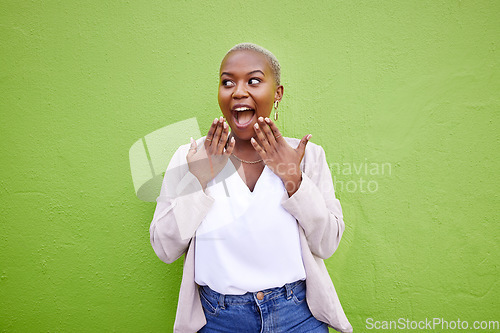 Image of Excited, thinking and black woman surprise by news, deal or discount offer isolated in a studio green background. Wow, gossip and young person with emoji reaction to announcement or promotion
