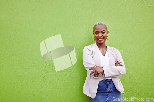 Image of Portrait, fashion and black woman smile with arms crossed on green wall background mockup space. Positive designer, happy and confident African person in style, casual clothes and trendy in Nigeria