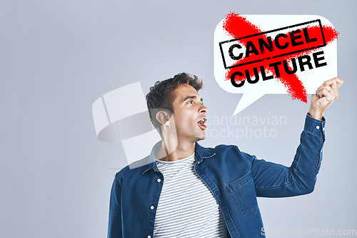 Image of Cancel culture, speech bubble and man with voice for support, censorship and opinion on grey background in studio. Poster, ban and social media influencer for freedom of vote, politics and propaganda