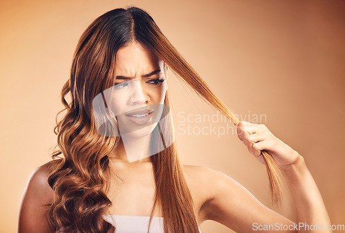 Image of Hair, problem and women with crisis and frustrated from salon treatment and Brazilian fail. Studio, brown background and angry model with damage from split ends and upset of bad and messy haircut