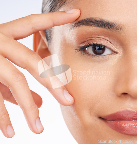 Image of Half face, closeup and woman with skincare, beauty or dermatology on a studio background. Portrait, person or model with grooming routine, luxury or wellness with facial, shine or glow with cosmetics