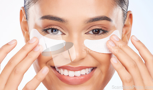 Image of Skincare, portrait and happy woman with eye patch for anti aging luxury skin glow on white background. Cosmetics, facial mask and face of model with solution or collagen pad for dermatology in studio