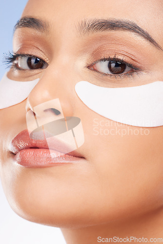 Image of Portrait, woman and eye patch for skincare and face health, dermatology and self care shine on studio background. Beauty, person and facial product with collagen mask, wellness and glow with zoom