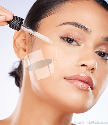 Image of Woman, portrait and oil serum for skincare, cosmetics and beauty product on a white background. Young person with facial liquid, dermatology dropper or collagen for skin care health on face in studio