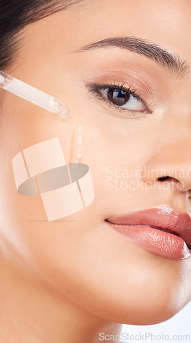 Image of Woman, face and oil serum for skincare, cosmetics and beauty product on a white background. Portrait of person in facial liquid, dermatology dropper or collagen for skin care zoom or makeup in studio