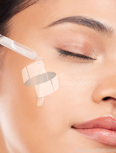 Image of Face, essential oil and woman in studio for skincare, wellness or serum and cosmetic application. Beauty, facial and female model with hydration, vitamin c or retinol, hyaluronic acid or skin primer