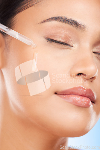 Image of Face, oil and woman in studio for skincare, wellness or hydration, serum or cosmetic application. Beauty, facial and female model with hydration, vitamin c or retinol, hyaluronic acid or skin primer