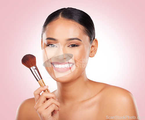 Image of Woman, makeup and portrait of brush in studio for beauty, skincare and aesthetic of face on pink background. Happy model, dermatology and cosmetics tools for foundation, facial powder and makeover