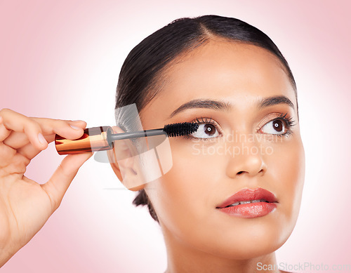 Image of Makeup, woman and mascara for beauty and skincare, cosmetics and eyelash extension in studio on pink background. Self care, person and brush for application, product and aesthetic for volume