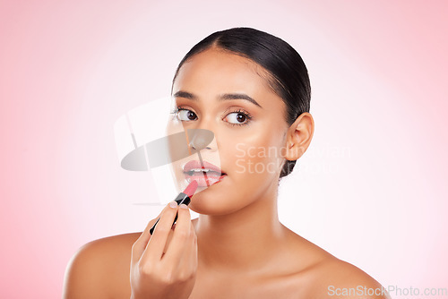 Image of Red, lipstick and face of woman with makeup or cosmetics on pink background space and thinking about product. Lips, beauty and model with ideas for aesthetic skincare or choice of color on mouth