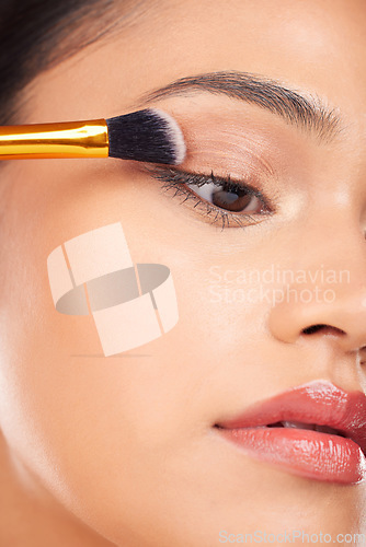 Image of Face makeup, eyeshadow brush and woman with studio cosmetics tools, beauty care product and closeup facial cosmetology. Foundation application, spa salon dermatology and aesthetic skincare model