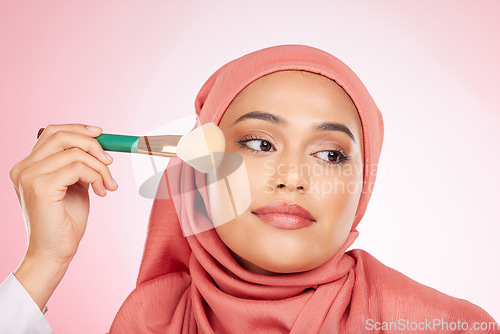 Image of Makeup, foundation brush and muslim woman with self care from cosmetics and blush in studio. Facial, glow and relax female person with beauty, skincare and shine with a hijab and skin tool for face