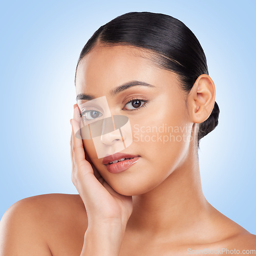 Image of Beauty, makeup and product with portrait of woman in studio for cosmetics, glow and self care. Health, skincare and dermatology with person on blue background for facial, salon and cosmetology