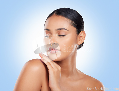 Image of Skincare, beauty and woman with cosmetics, wellness and dermatology on a blue studio background. Self care, person or model with luxury, cosmetology or facial with aesthetic, grooming or healthy skin