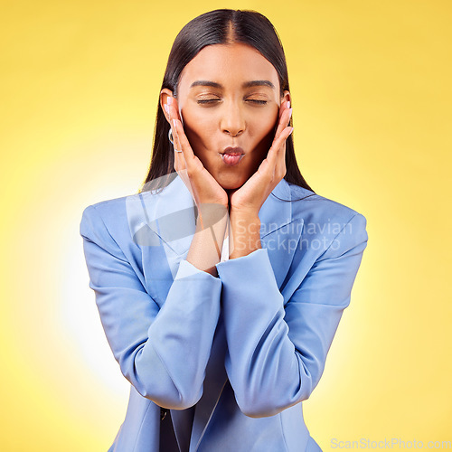 Image of Hands, lips pout and woman with eyes closed in studio isolated on a yellow background. Face touch, happy model and kiss for skincare, beauty and natural cosmetics in facial treatment with manicure.