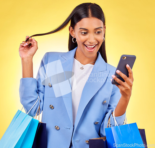 Image of Shopping, phone and woman with surprise as customer happy for retail fashion isolated in studio yellow background. Shocked, online and young person with discount, deal and promo on clothes or product