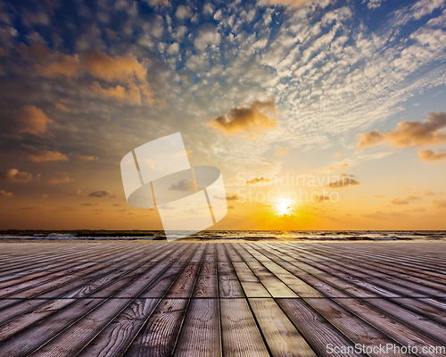Image of Wooden surface under sunset sky