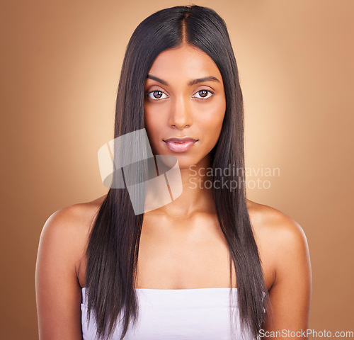 Image of Portrait, hair care and woman with beauty, skincare and dermatology on a brown studio background. Face, person or model with aesthetic, luxury and glow with healthy skin, texture or volume with shine