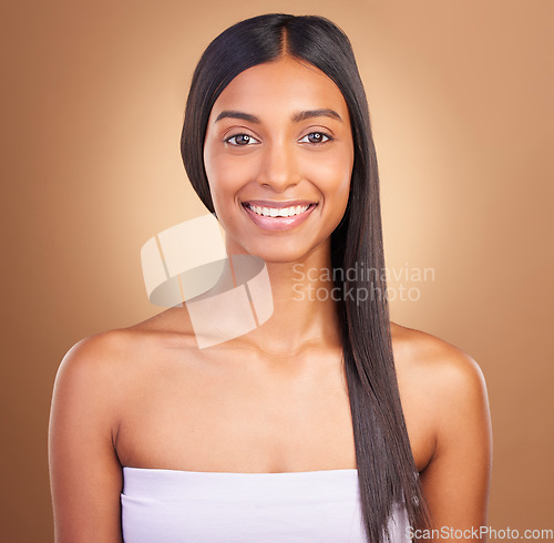 Image of Portrait, hair care and woman with beauty, dermatology and skincare on a brown studio background. Face, person and model with shine, aesthetic or glow with healthy skin, wellness or volume with smile