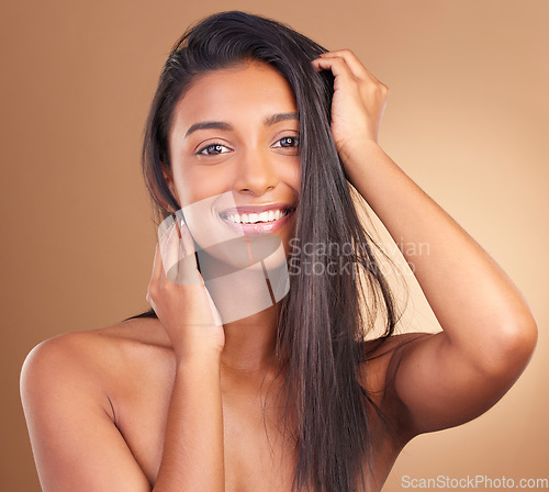 Image of Hair, beauty and portrait of happy Indian woman in studio for cosmetic, wellness or texture and growth on brown background. Haircare, face and lady model smile for keratin, volume or shampoo results