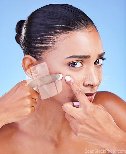 Image of Acne, problem and portrait of woman with pimple in studio for cosmetic, mistake or disaster on blue background. Beauty, fail and face of female model with sensitive skin and diy blackhead removal