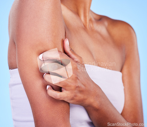 Image of Arm injury, stress and hands of woman in studio with arthritis, osteoporosis or emergency on blue background. Shoulder, accident and lady person with joint pain massage for osteoarthritis relief