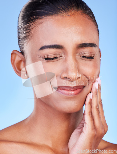 Image of Toothache, sad and a woman with mouth pain on a blue background with a dental emergency. Dentist, frustrated and a girl with a problem with a teeth injury, gingivitis or inflammation of a gum