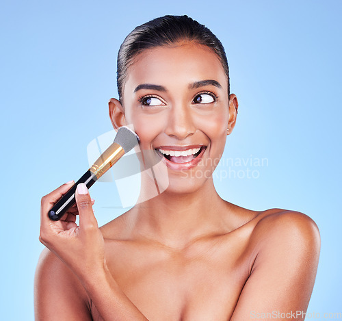 Image of Beauty, face and woman with makeup brush in studio for powder, cosmetic or application on blue background. Foundation, skincare and lady model with cheek tools for contour, cover or facial treatment