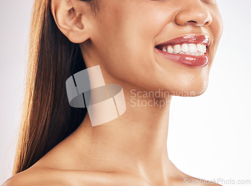 Image of Woman, face and teeth whitening with smile, dental and health, skin and lip gloss on white background. Mouth wellness, oral healthcare and orthodontics, veneers and makeup, cosmetic care in studio