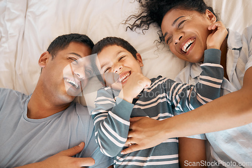 Image of Funny, tickle and relax with family in bedroom for playful, morning and love from above. Care, support and wake up with parents and child in bed at home for weekend, positive and happiness together