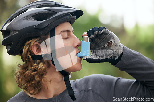 Image of Asthma, cyclist and man with medical emergency and breathing medicine in a forest for exercise or fitness. Lung, training and young person with support for health, wellness and relief inhaler