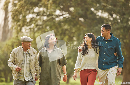 Image of Love, walking and smile with big family in park for bonding, support and summer. Vacation, happy and holiday with people relax in grass field in nature for peace, generations or care together
