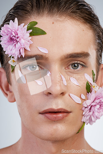 Image of Natural, skincare and flowers with portrait of man in studio for spring, beauty cosmetics and creative. Glow, non binary and floral with face of model on white background for makeup, spa and wellness