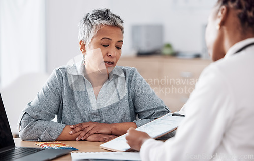 Image of Paperwork, doctor or consulting a patient in meeting talking in hospital for history or healthcare record. People, medical info or nurse with mature woman speaking of test results, update or document