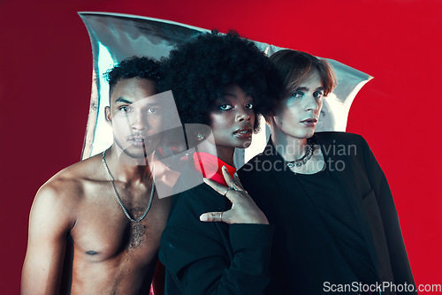 Image of Queer, diversity and portrait of people in fashion with creative black woman, gay man and model on red background in studio. Lgbt, friends and beauty for edgy, aesthetic or unique makeup and clothes