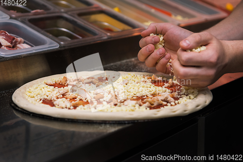 Image of making pizza at kitchen of pizzeria