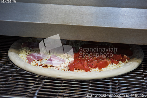 Image of Preparing pizza in oven