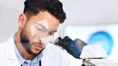 Image of Laboratory scientist using microscope to examine monkeypox virus and note his discovery. Closeup of serious biochemist engineer doing medical research with scientific equipment for breakthrough cure