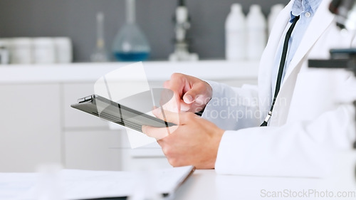 Image of Laboratory scientist typing on a digital tablet and examining a dna test reaction to monkeypox virus during medical research. Biochemical engineer searching for a breakthrough cure on technology