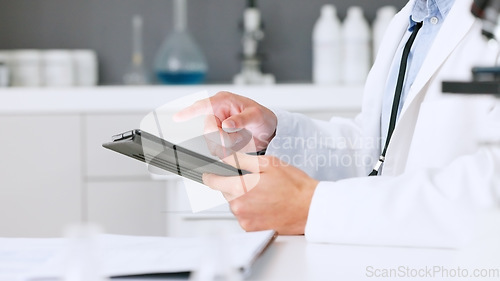 Image of Laboratory scientist scrolling on a digital tablet and examining a dna test reaction to monkeypox virus during medical research. Biochemical engineer searching for a breakthrough cure on technology