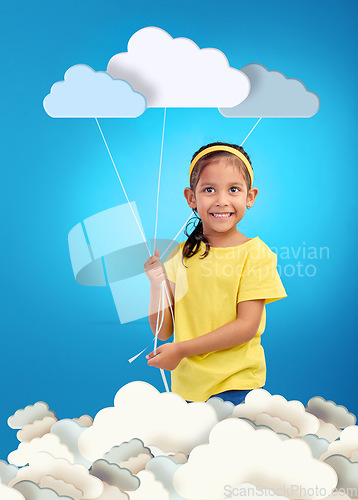 Image of Creative, portrait and girl child with paper clouds in studio for art, fun or project with mockup on blue background. Kindergarten, poster and face of kid with banner for learning, weather or message