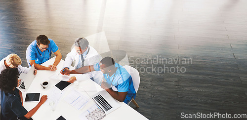 Image of Healthcare, meeting and doctors with nurses, laptop or tablet from above for surgery, advice or planning. Hospital, teamwork or people in office for help, collaboration or results, review or analysis